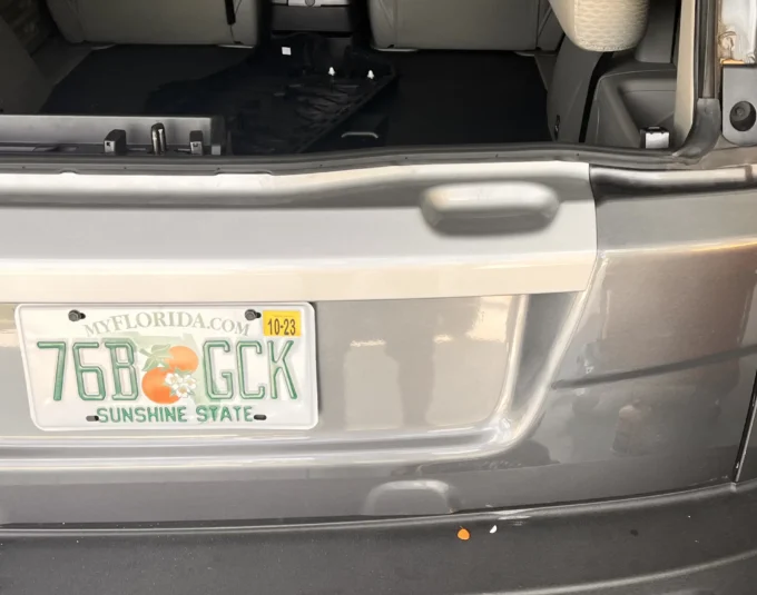 The opened-up back of a grey SUV with its interior shown.